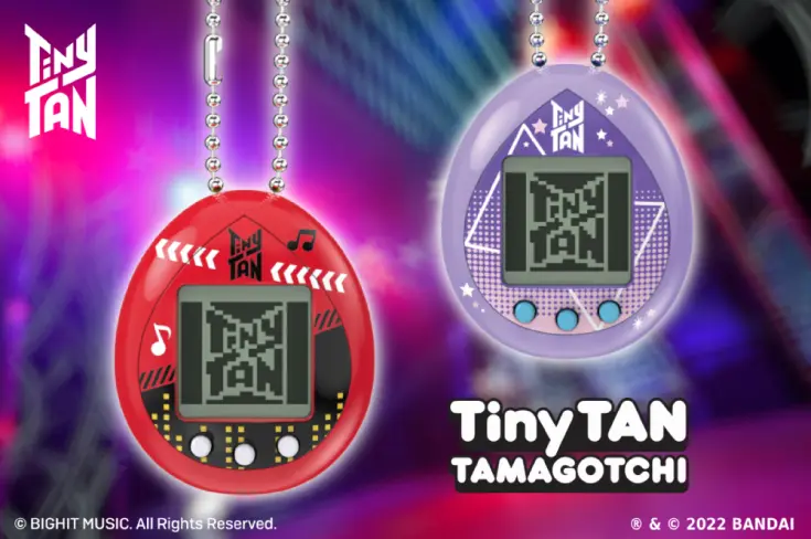 Two BTS Tamagotchis, one red and one purple, against a backdrop of colorful lights